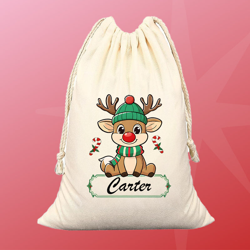 Drawstring bag with a cartoon reindeer wearing a green hat and scarf, on a pink and red background.