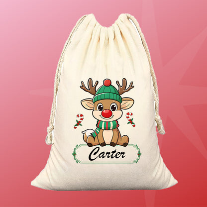 Drawstring bag with a cartoon reindeer wearing a green hat and scarf, on a pink and red background.