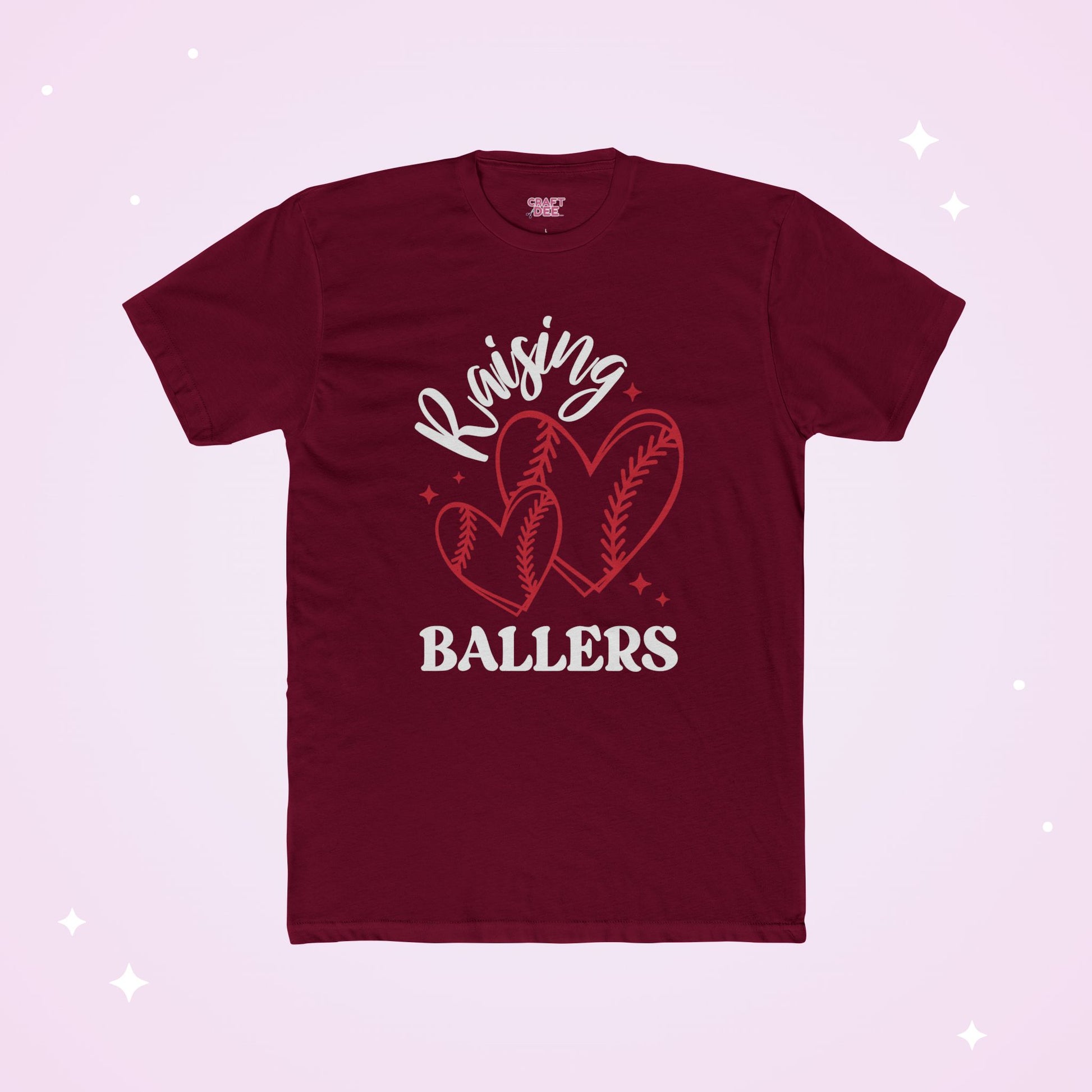 Maroon t-shirt with 'Raising Ballers' design on a light pink background