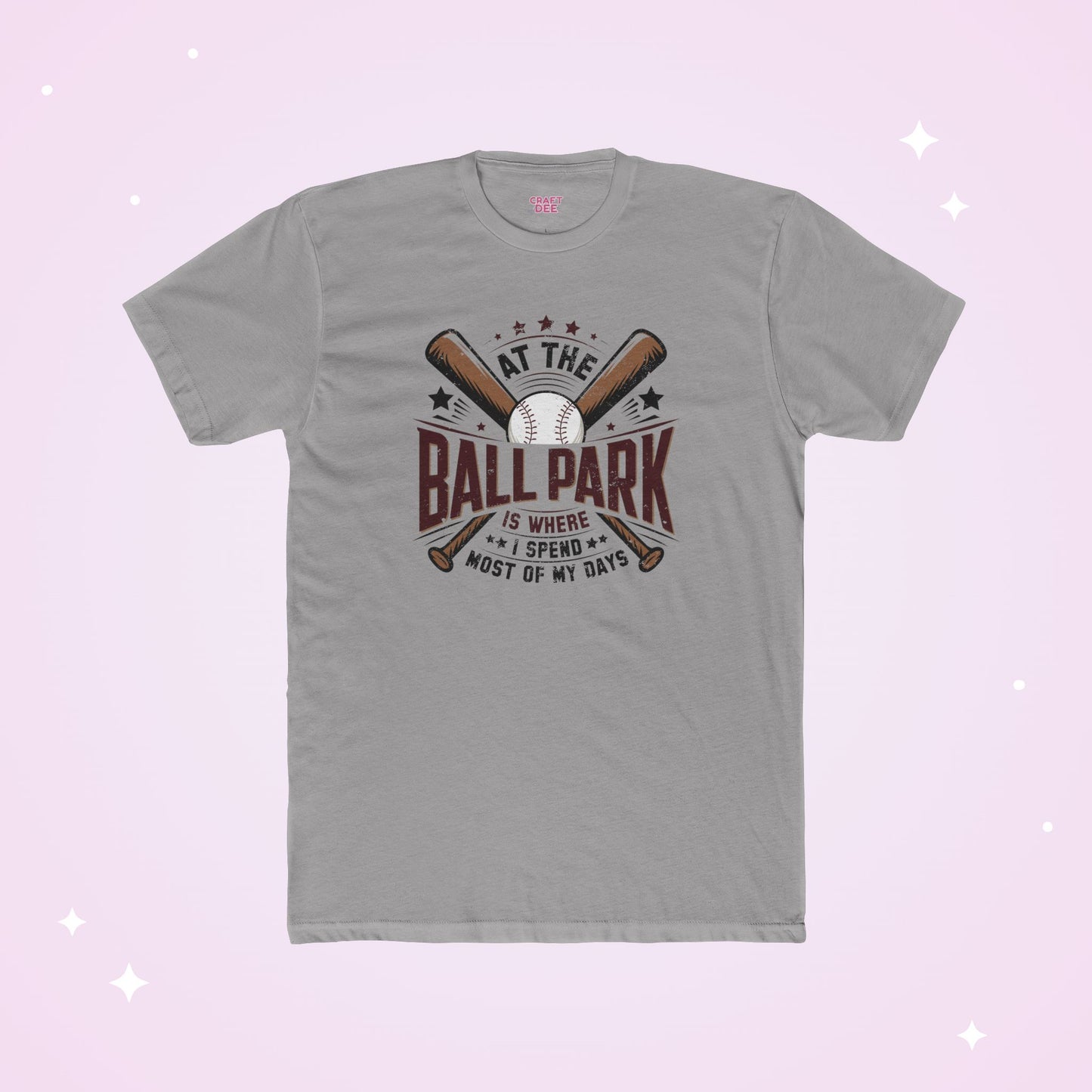 Gray t-shirt with baseball graphic and text on a light purple background