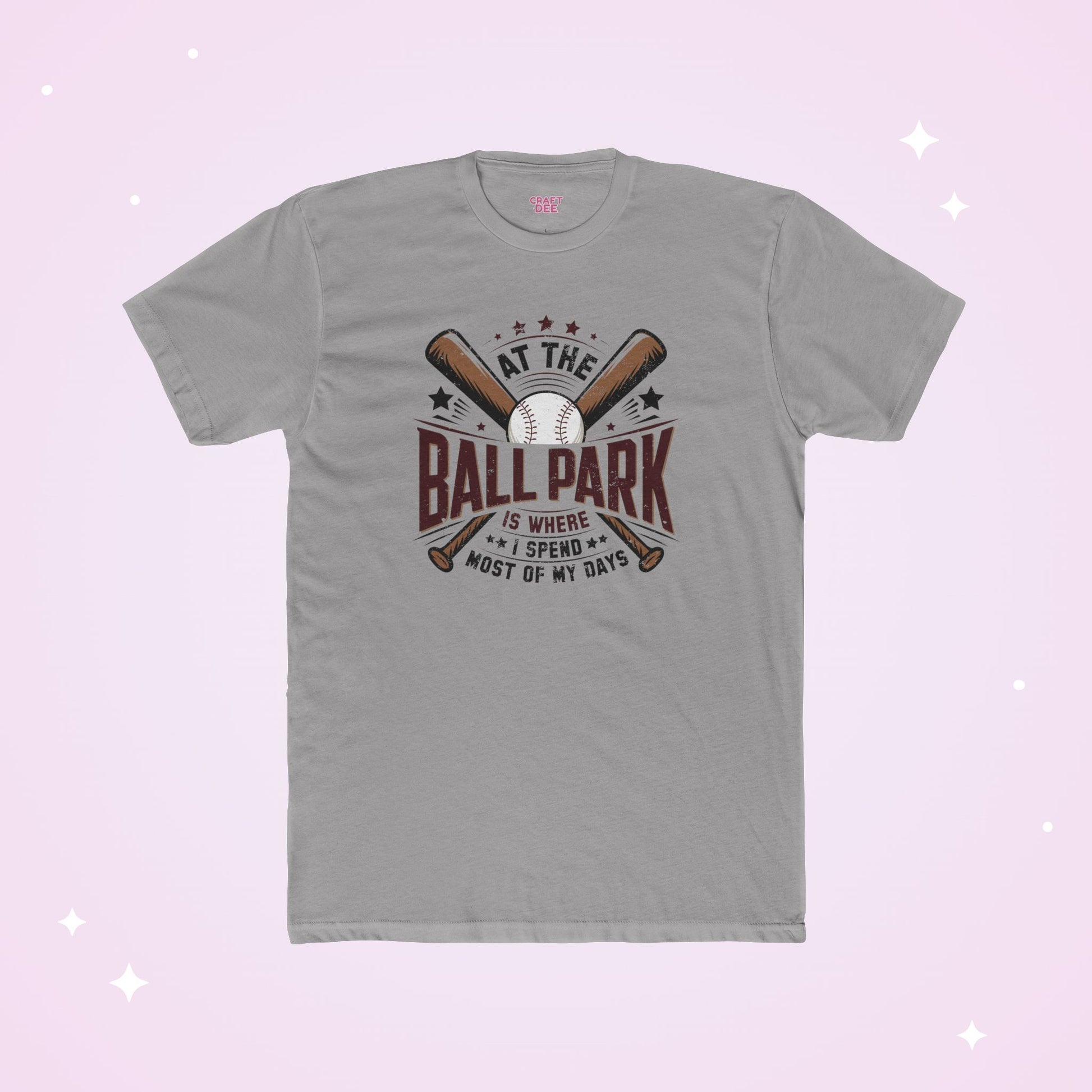 Gray t-shirt with baseball graphic and text on a light purple background