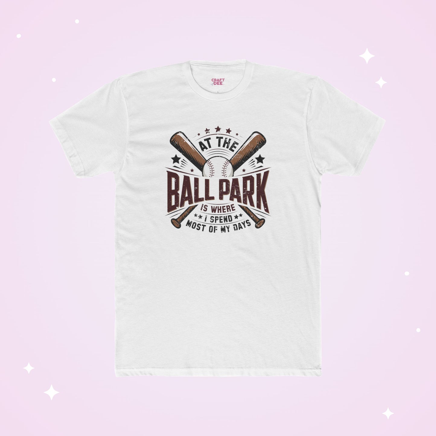 White t-shirt with baseball graphic and text on a light pink background