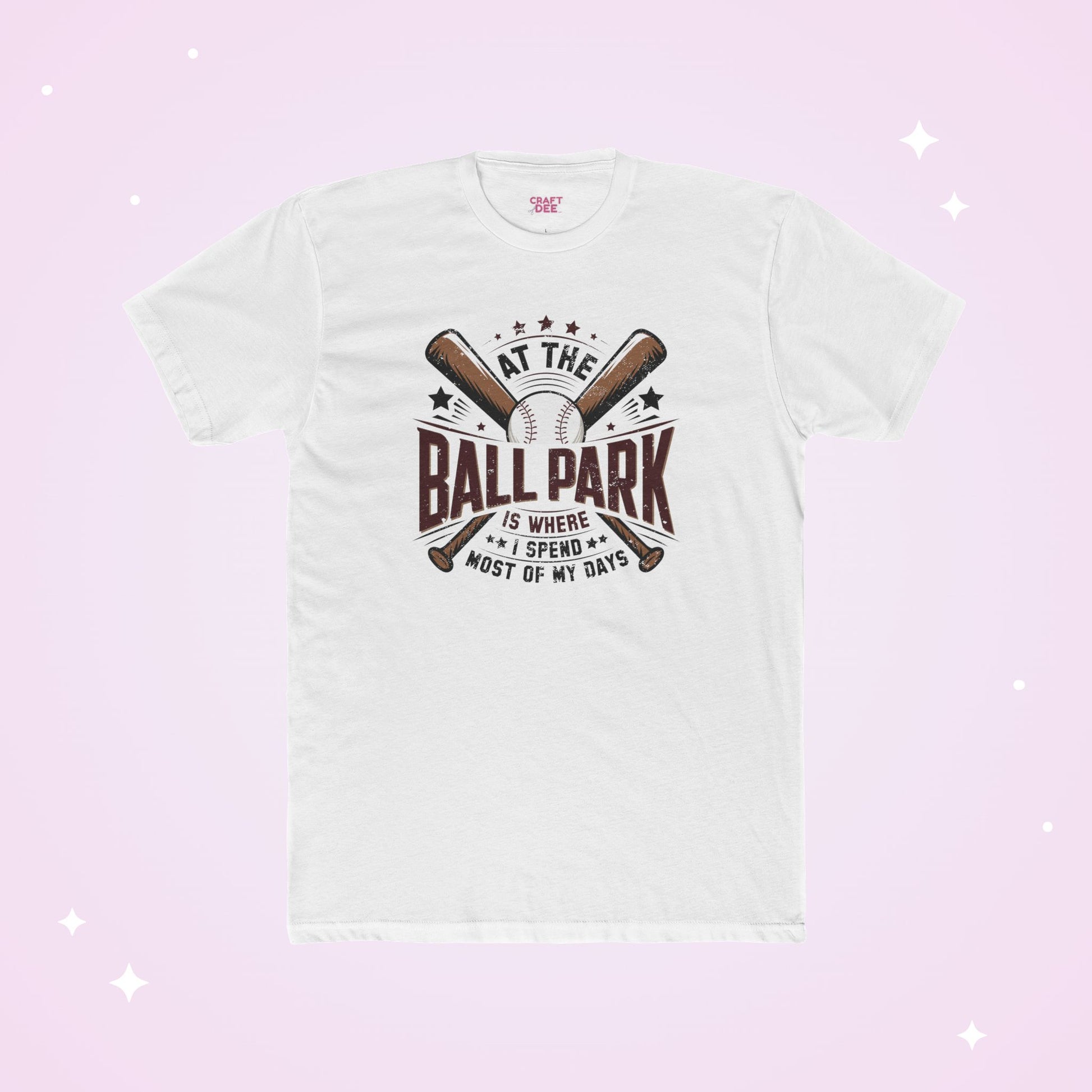 White t-shirt with baseball graphic and text on a light pink background