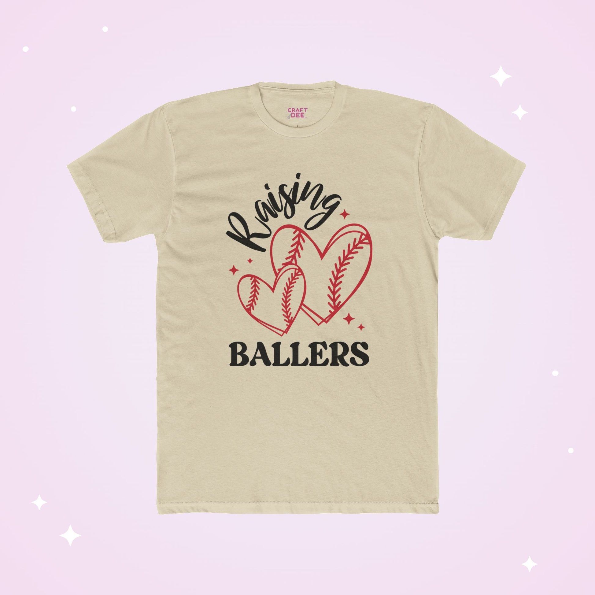 Beige t-shirt with 'Raising Ballers' text and baseball heart graphics on a light pink background