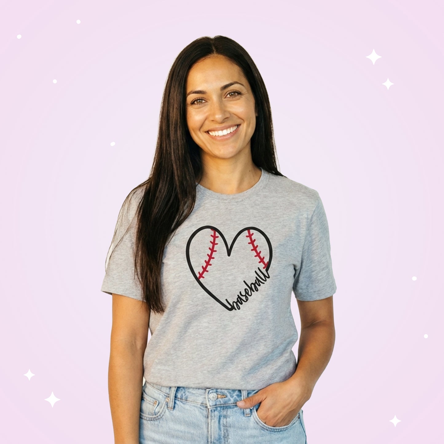 Woman wearing a gray t-shirt with a heart-shaped baseball design on a light purple background