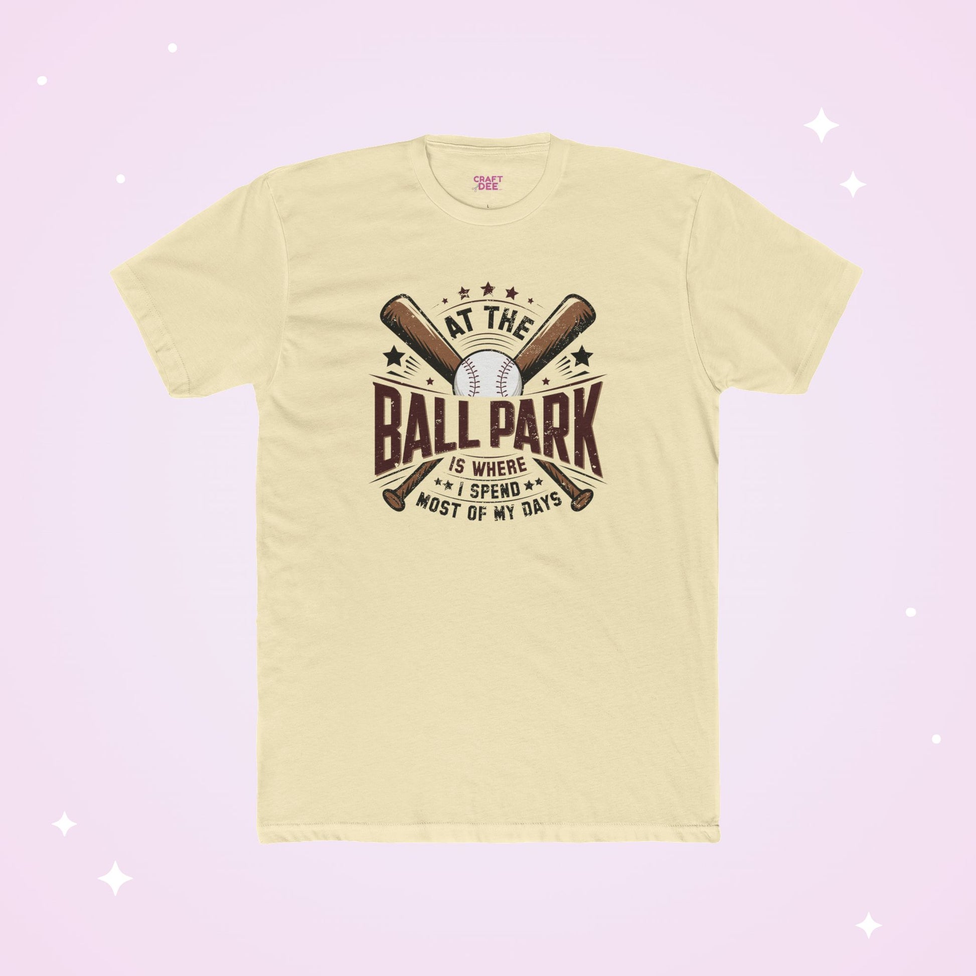 Light yellow t-shirt with baseball graphic and text on a light purple background