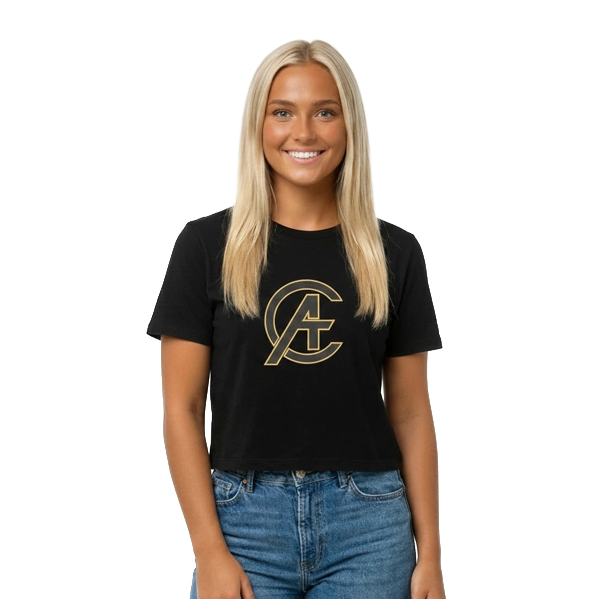 A smiling blonde woman wearing a black short-sleeve crop top t-shirt with a gold circular 'AC' logo on the chest, paired with blue jeans, against a plain white background.