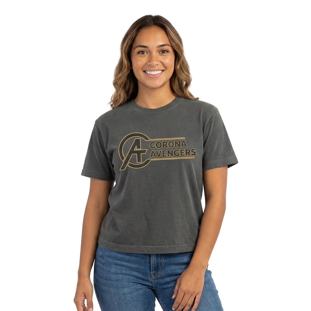 A woman wearing a dark gray short-sleeve t-shirt with a distressed gold 'Corona Avengers' logo on the chest, paired with blue jeans, set against a plain white background.