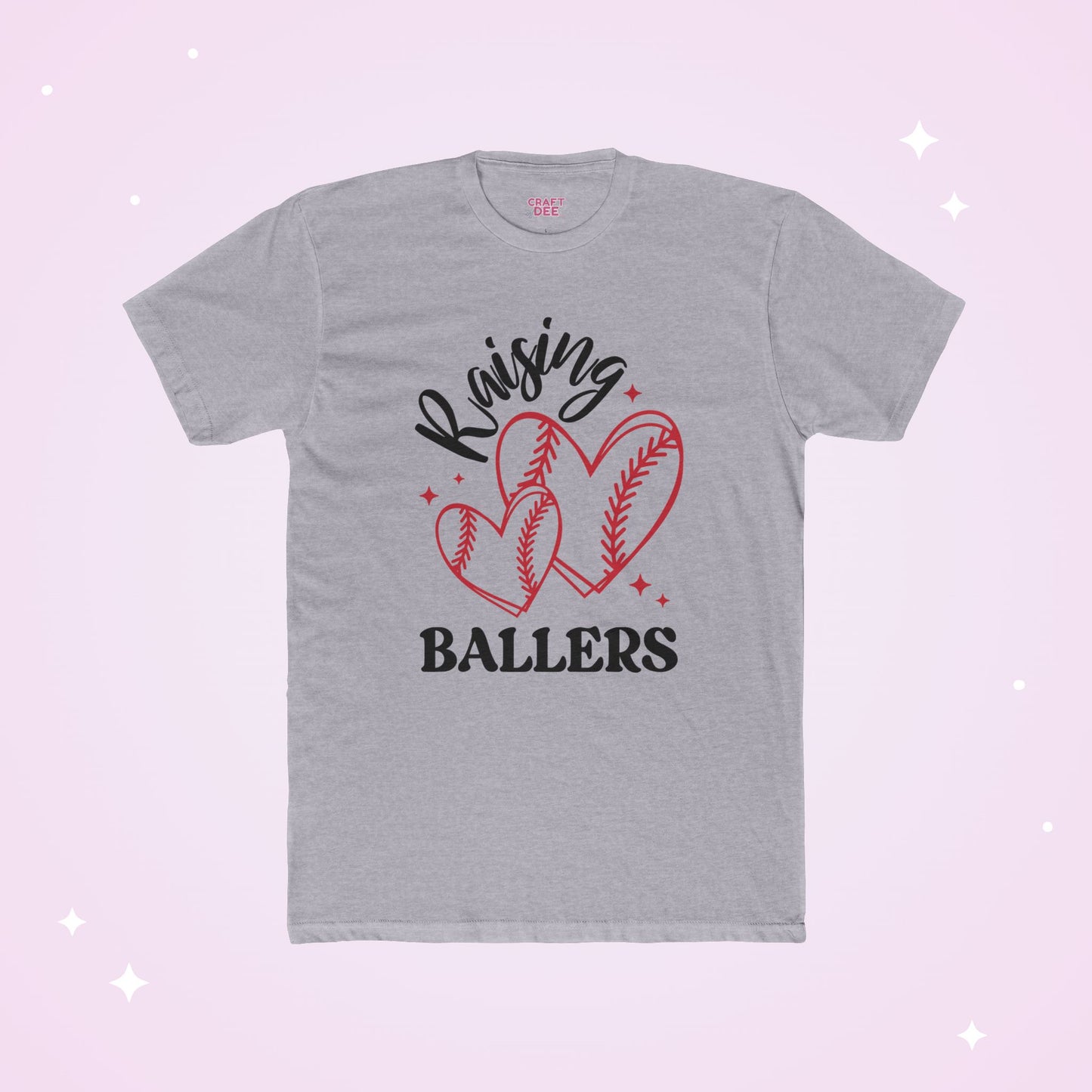 Gray t-shirt with 'Raising Ballers' text and heart-shaped baseball designs on a light pink background