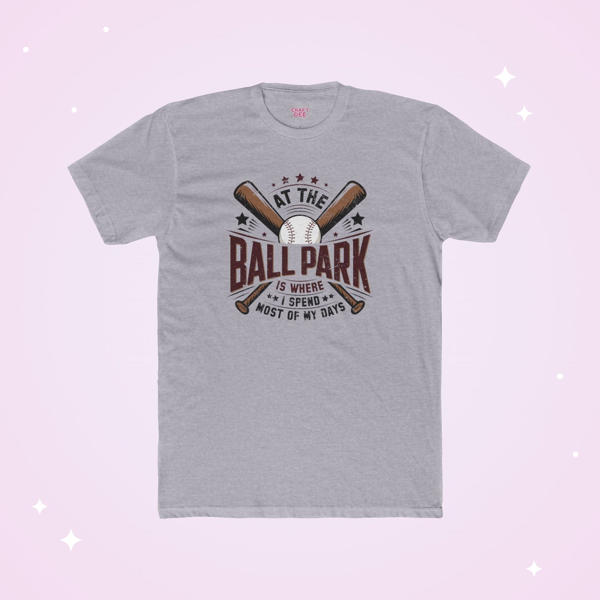 Gray t-shirt with baseball-themed design on a light purple background
