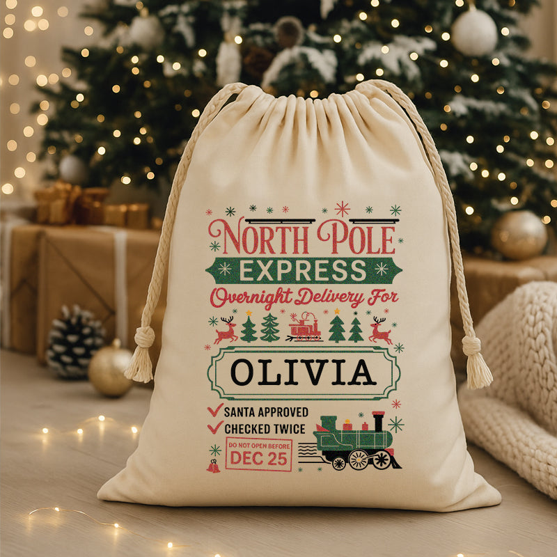 Personalized Christmas gift bag with festive design in front of a decorated Christmas tree.