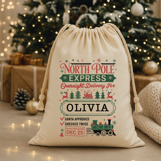 Personalized Christmas gift bag with festive design in front of a decorated Christmas tree.