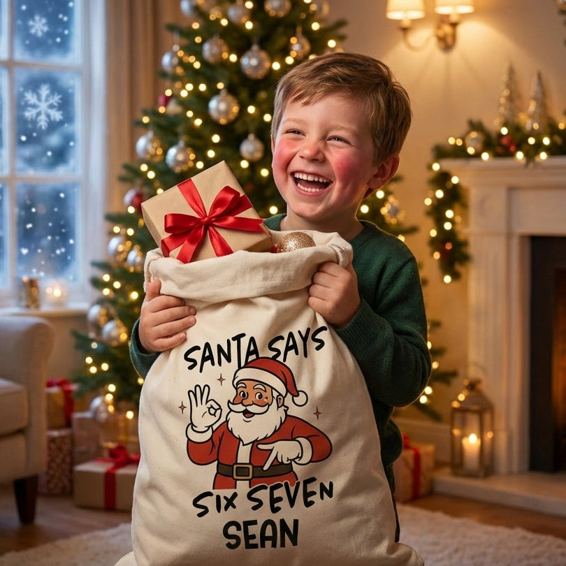 Young Boy opening up his custom christmas santa sack in front of a christmas tree and fireplace.