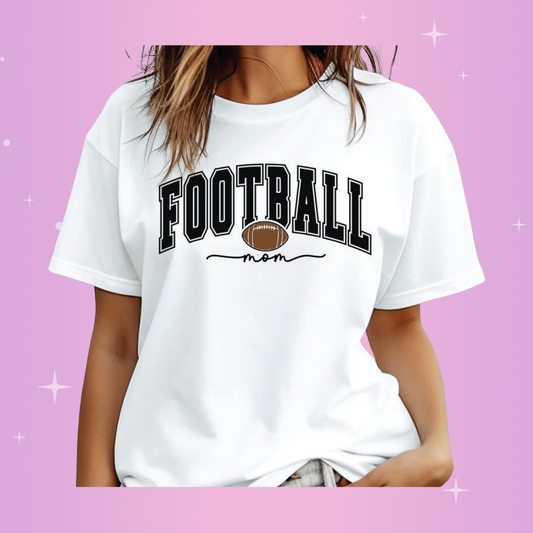 A woman wearing a white crew neck t-shirt with the text 'FOOTBALL mom' printed on the front.