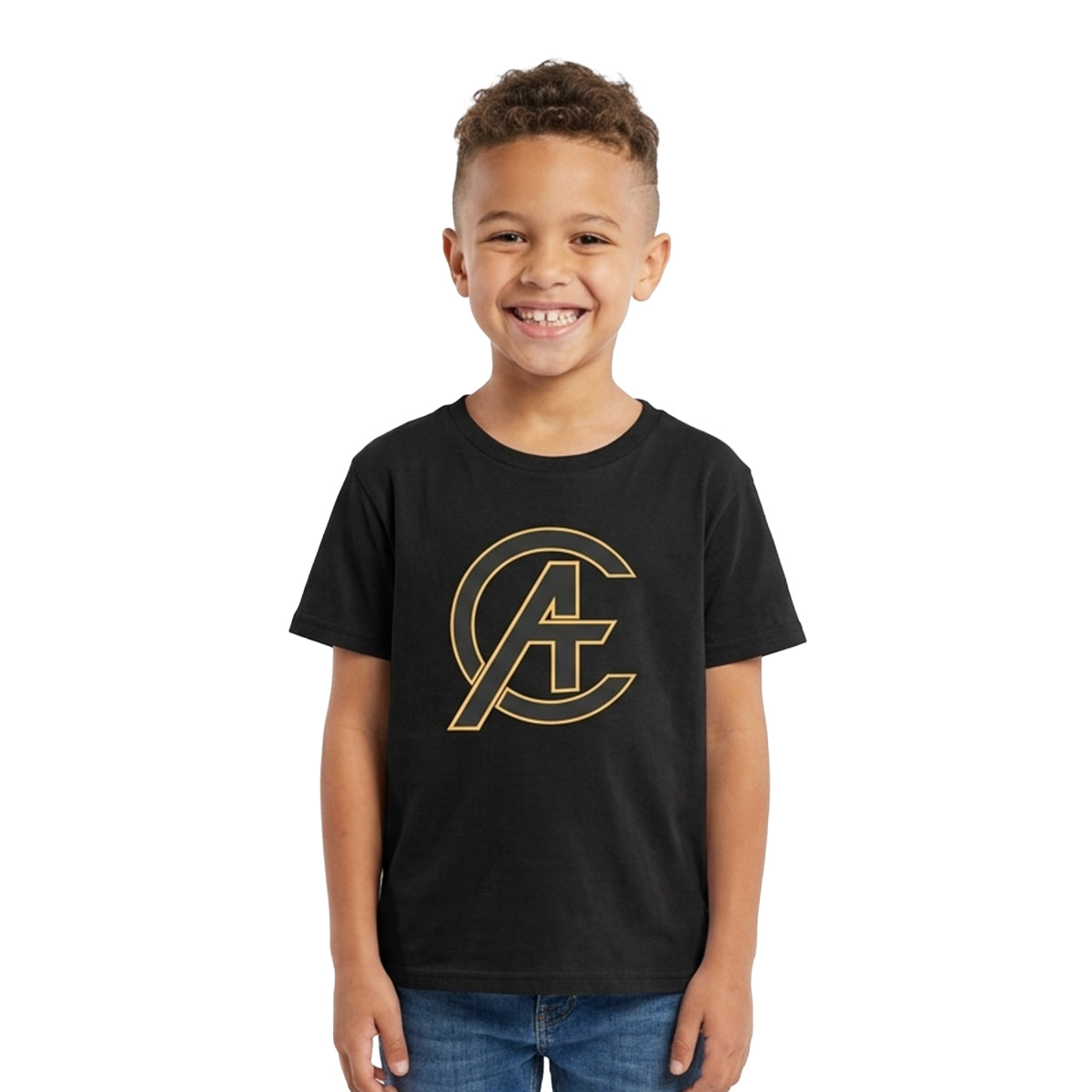 A young boy smiling and wearing a black short-sleeve t-shirt with a gold Avengers 'CA' logo on the chest, paired with blue jeans, set against a plain white background.