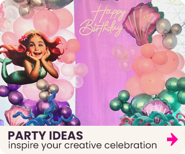 Mermaid-themed birthday party decorations with balloons and a 'Happy Birthday' sign with custom mermaid cutout