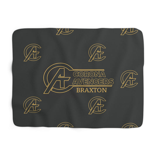 A dark gray rectangular mat or pad featuring a repeating gold outline of the Avengers 'A' logo and vertical text reading 'CORONA AVENGERS BRAXTON' in the center, shown on a plain white background.